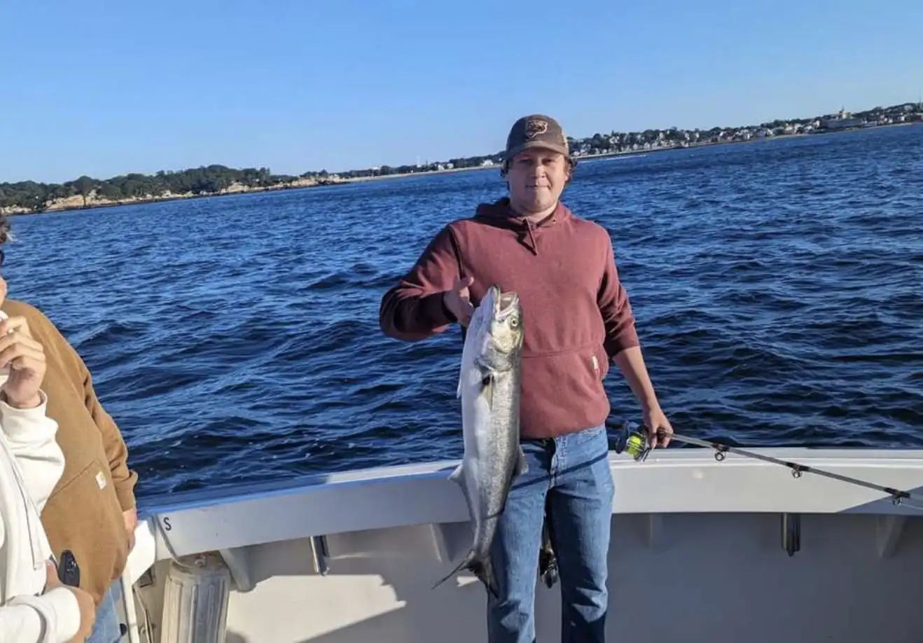 Another client laughs with a fish in his mouth on Tuna Tail Charters.