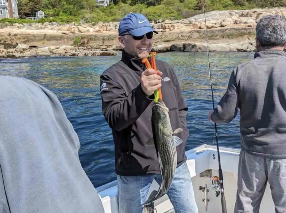 A couple stands in shallow water—Tuna Tail Charters prefers deeper seas.