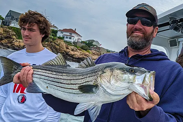 Anglers preparing for a summer deep sea fishing trip in Gloucester, organizing gear and readying the boat